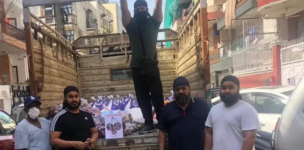 Bright Pines volunteers beside a truck loaded with dry ration packets in Delhi